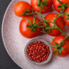 Fresh red cherry tomatoes on a branch on a dark concrete backgro Pomodoro Ailsa Craig