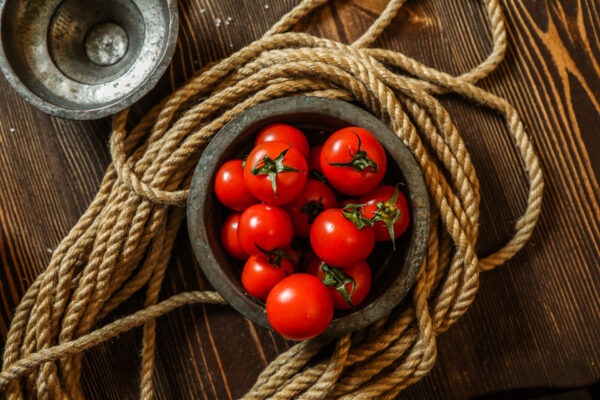 top view cherry tomatoes in a wooden bowl with rope on the table Pomodoro Baxter semi